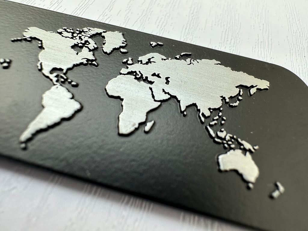 Close-up view of the raised Silver World Map on the back of the Black Luggage Tag