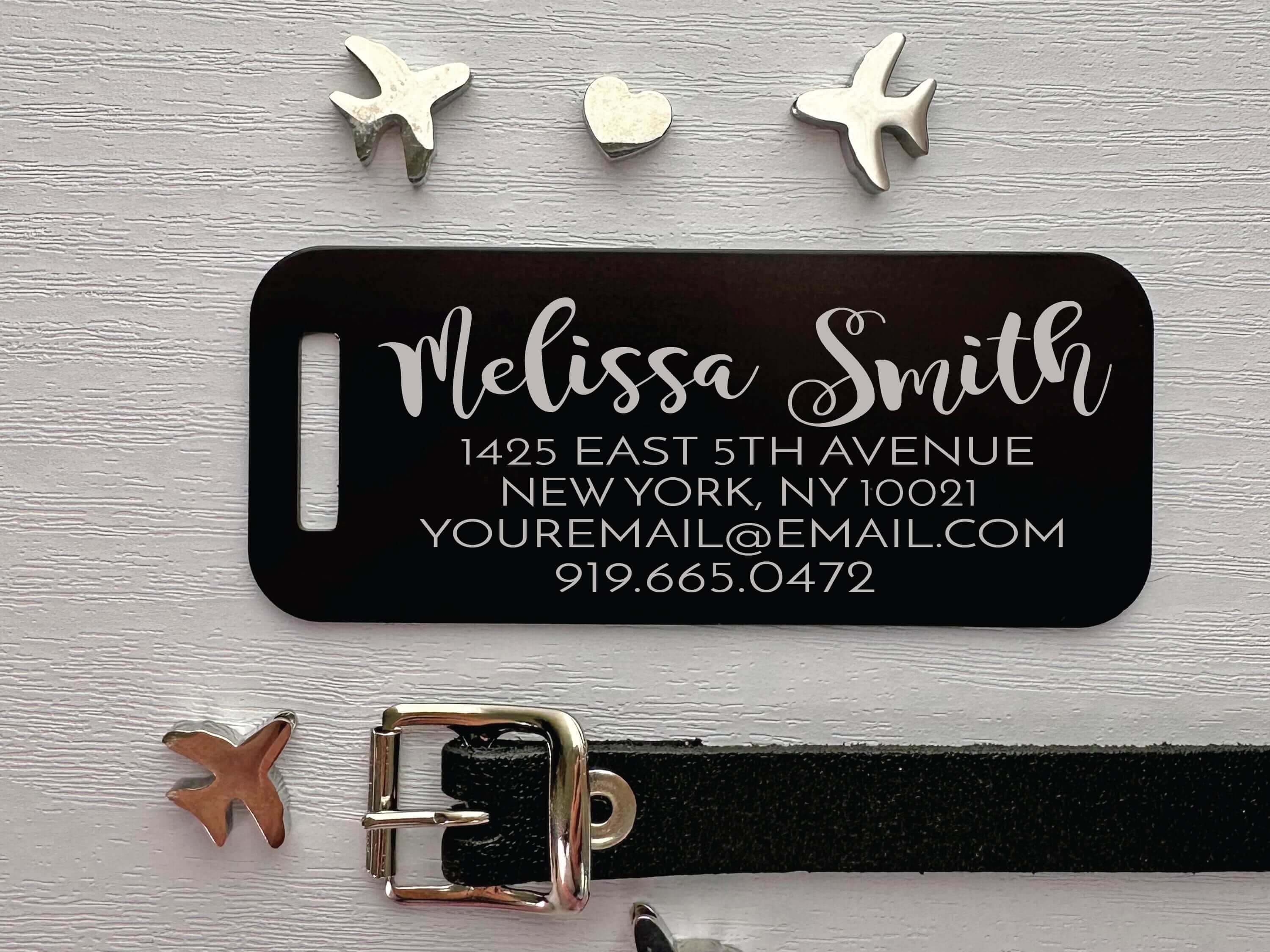 Premium black metal luggage tag engraved with custom nameplate details