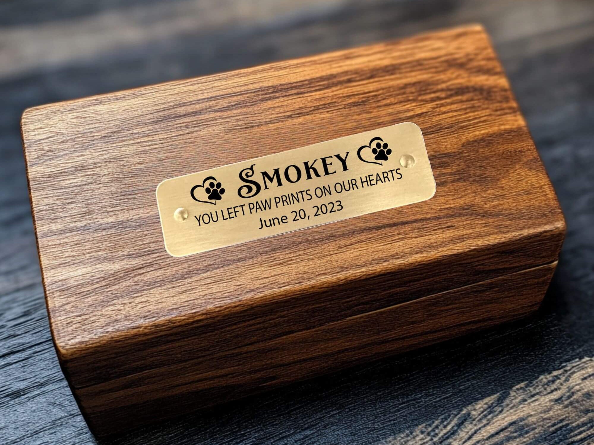 Custom pet memorial plaque with engraved text and self-adhesive backing.