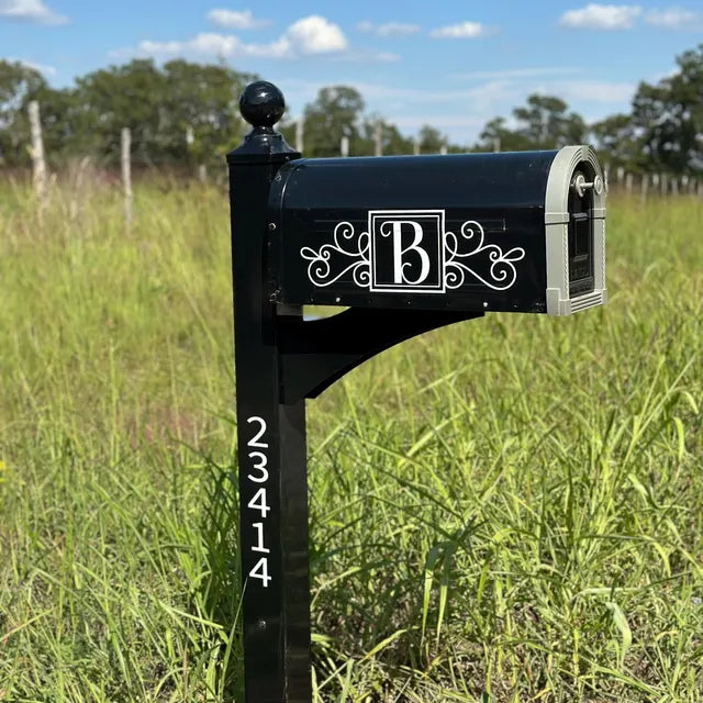 Custom black mailbox with personalized white vinyl decal, featuring intricate design and house number. Custom mailbox decals for home decor and curb appeal.