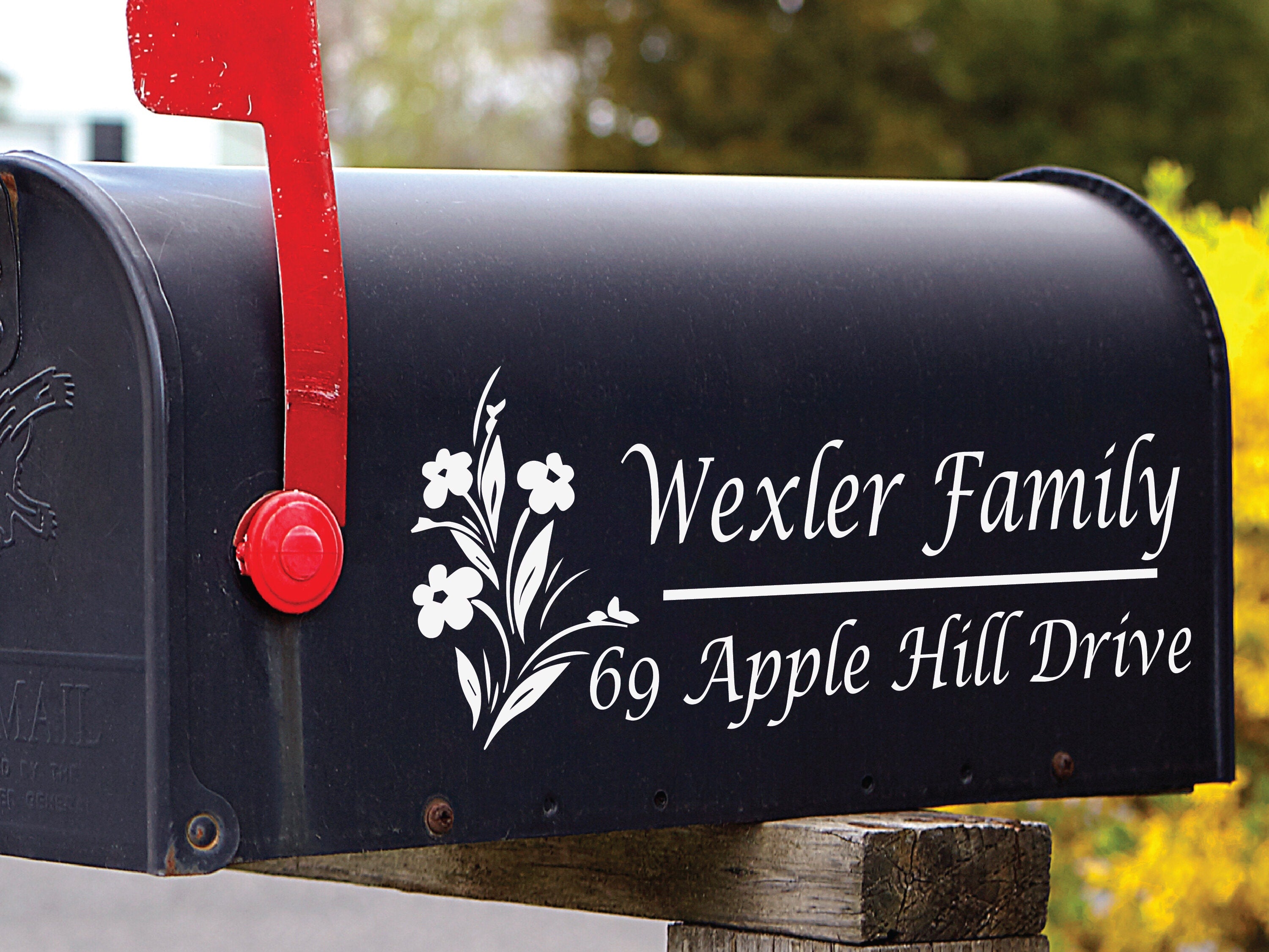Black mailbox with floral decal featuring personalized family name