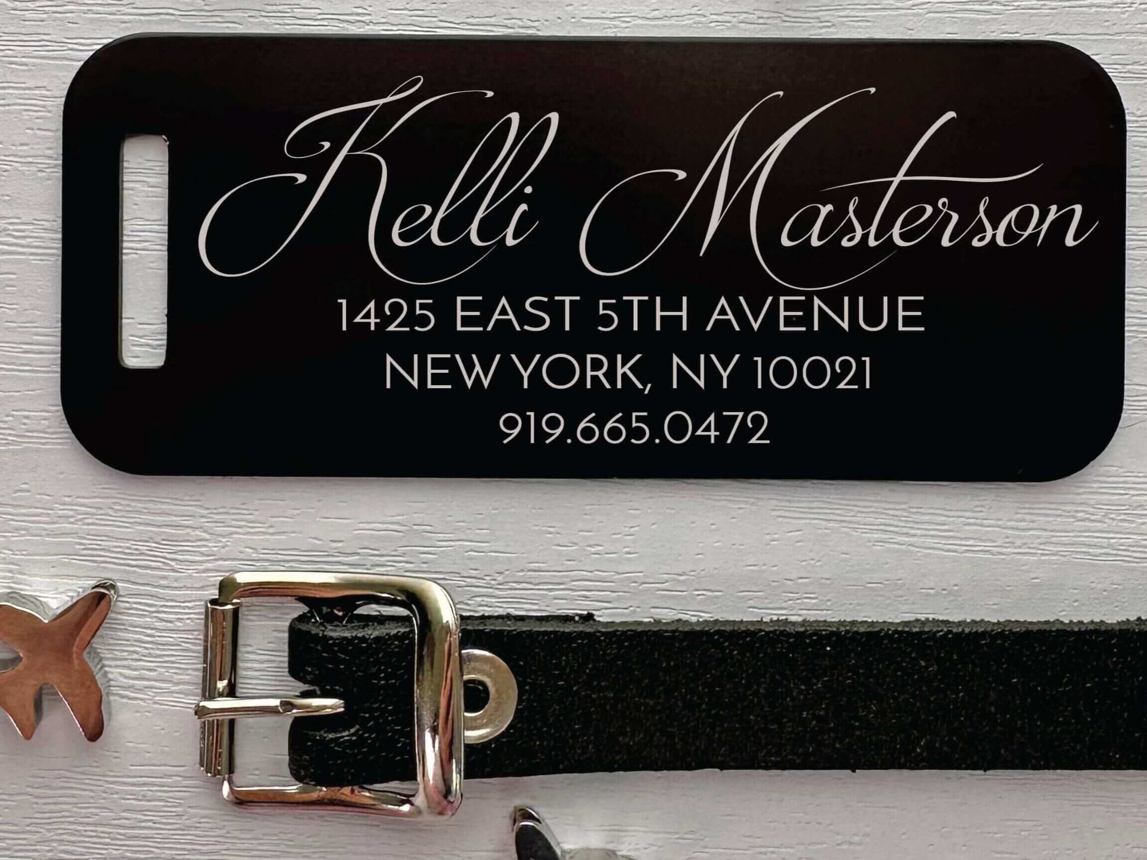Elegant black luggage tag with script name engraving and leather strap