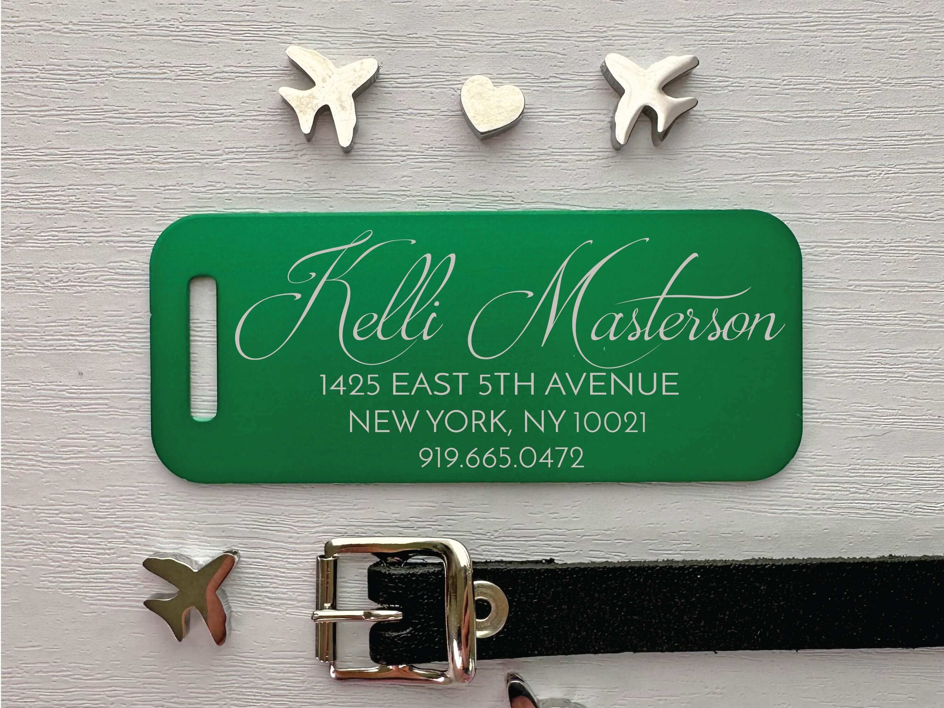 Personalized green luggage tag with laser-engraved script name and address