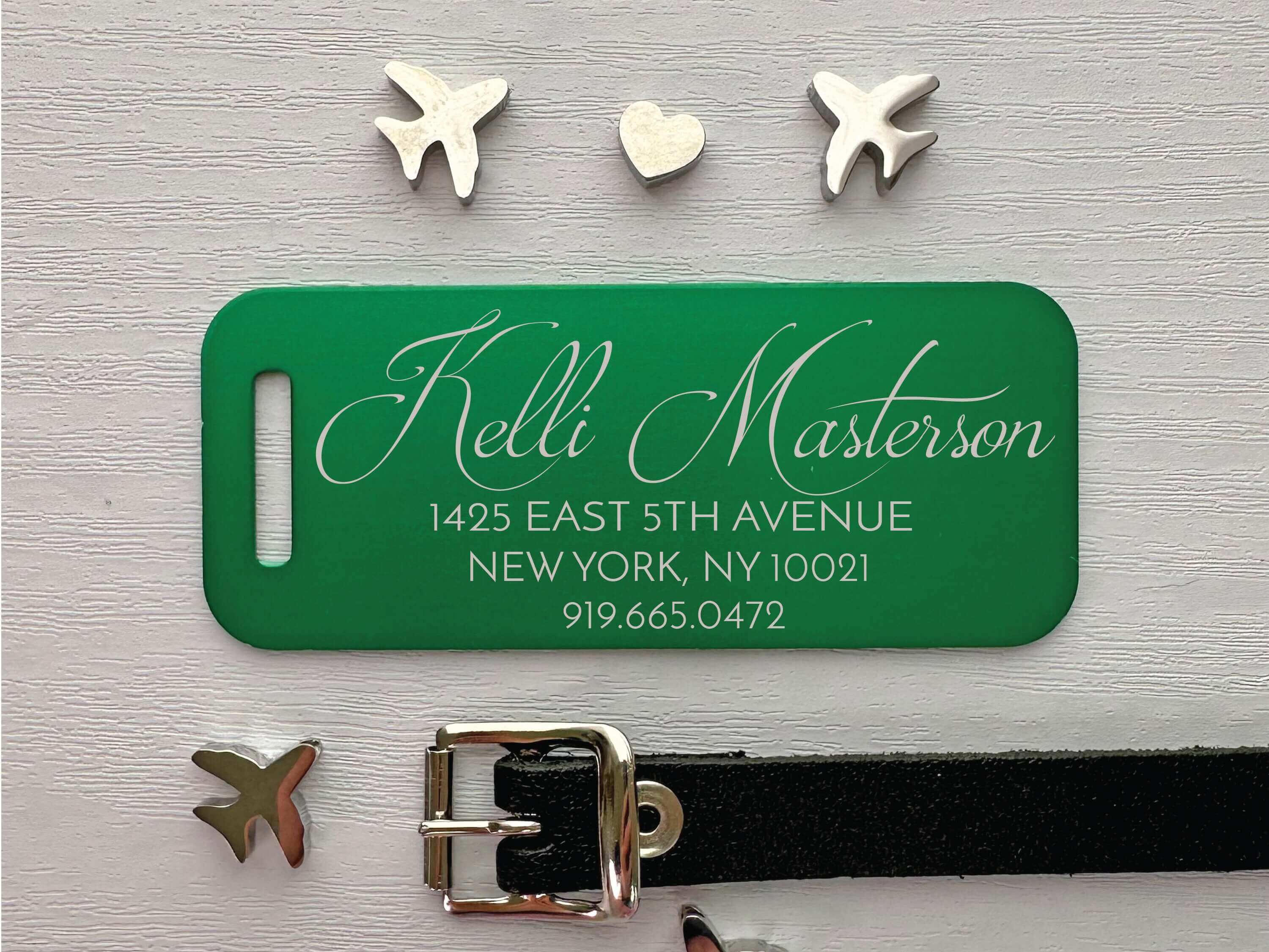 Personalized green luggage tag with laser-engraved script name and address