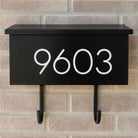 Vinyl mailbox number decal on a black wall-mounted mailbox in modern sans serif font