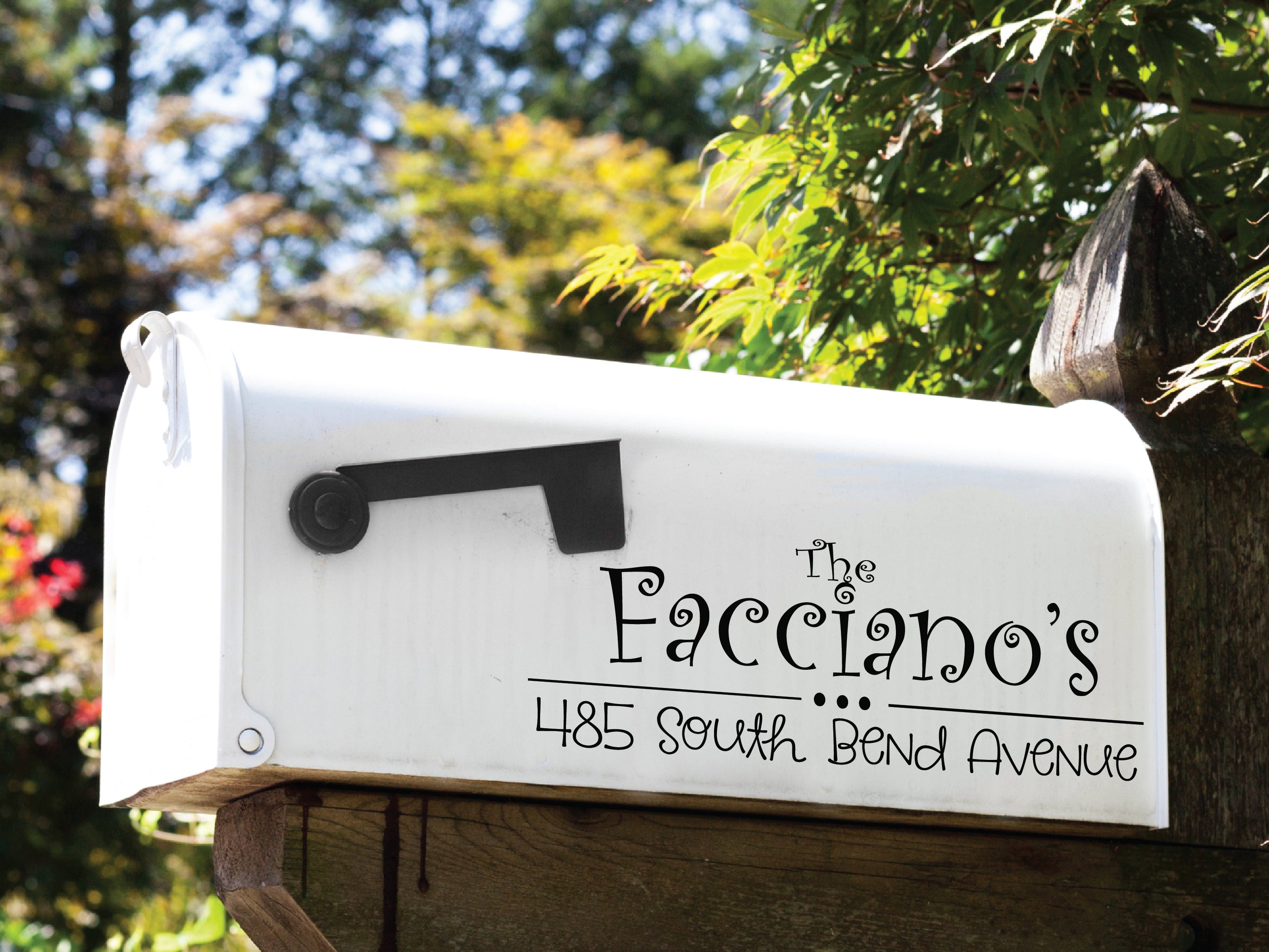 Outdoor mailbox with durable vinyl lettering applied on black finish