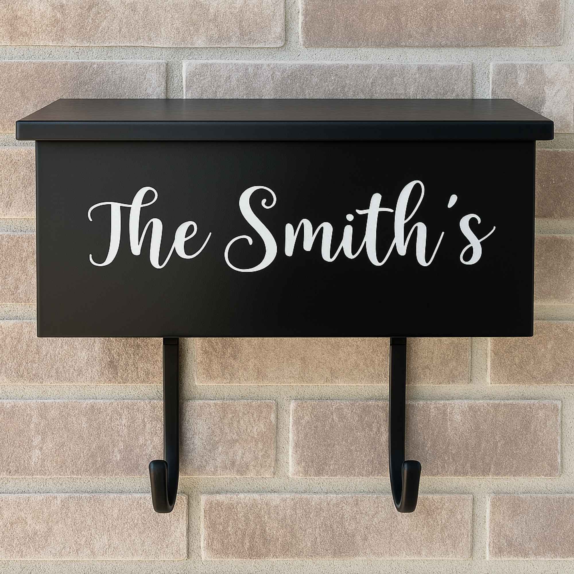 Custom vinyl decal reading "The Smith's" applied to a wall-mounted black mailbox