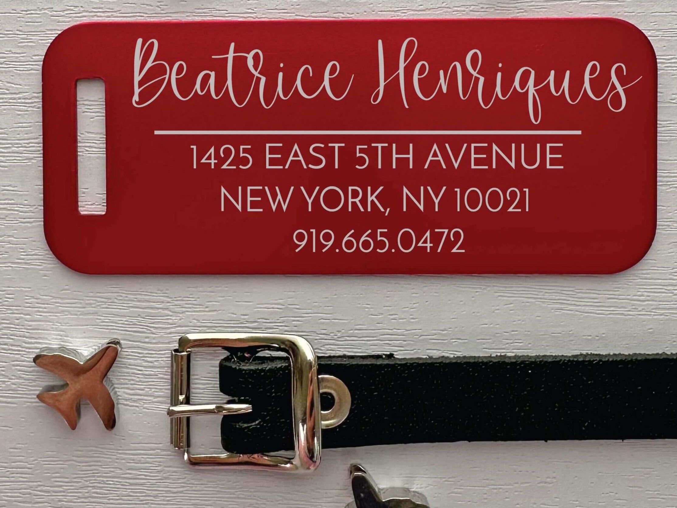 Bright red travel tag with laser engraved personal info