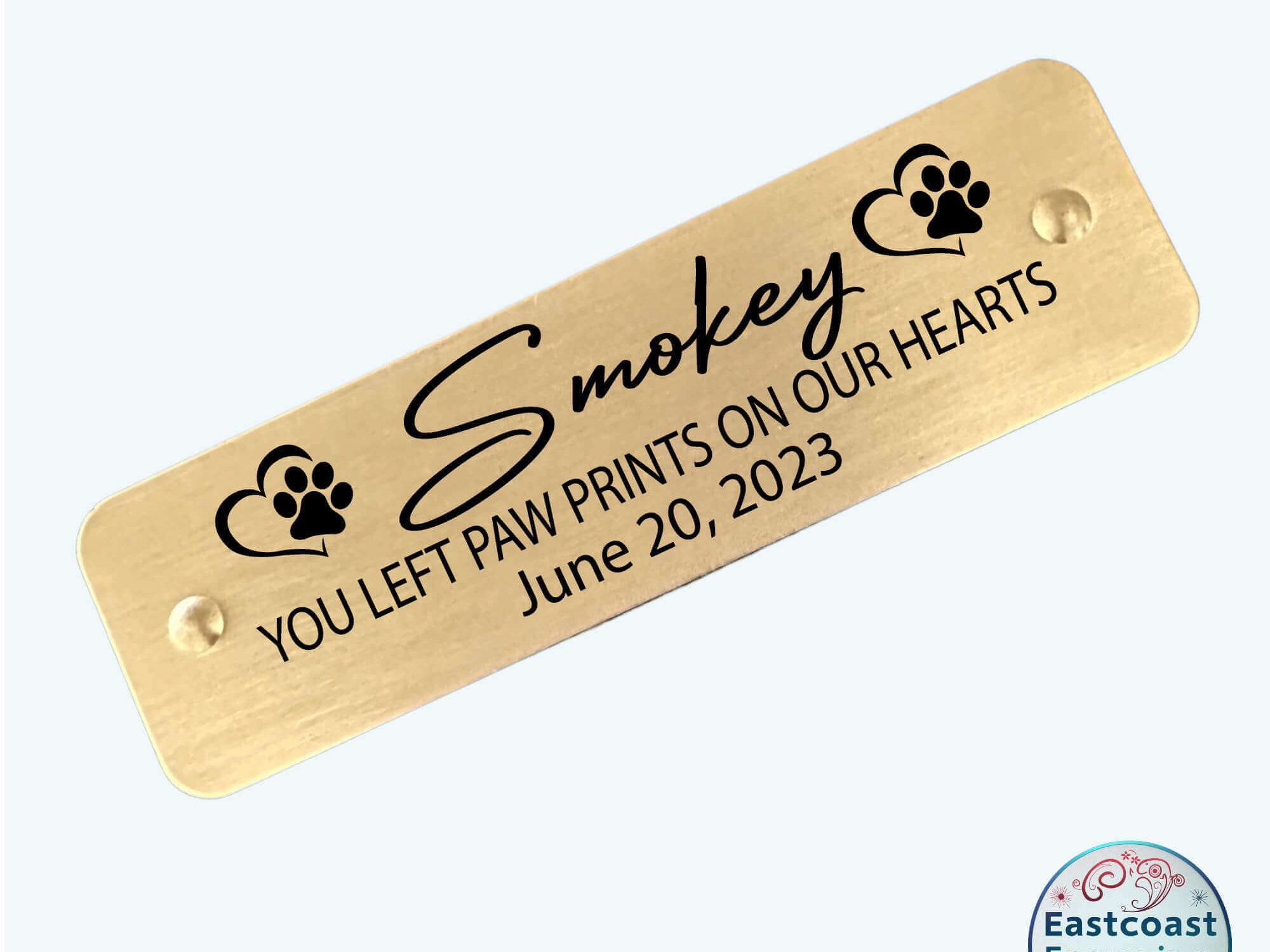 Personalized brass pet memorial tag, self-adhesive for easy application.