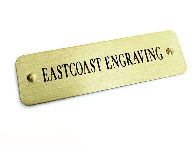 Personalized brass adhesive labels for flat surfaces