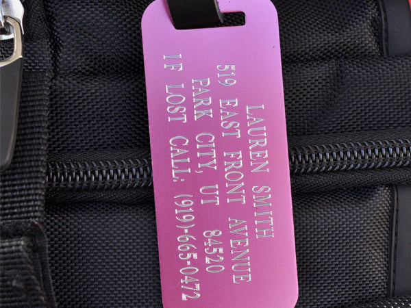 Custom pink aluminum luggage tag with engraved contact info and leather strap for backpacks, suitcases, and kids’ bags