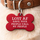 red bone-shaped dog ID tag engraved with “Lost AF Have Your People Call My People” hanging from a dog collar