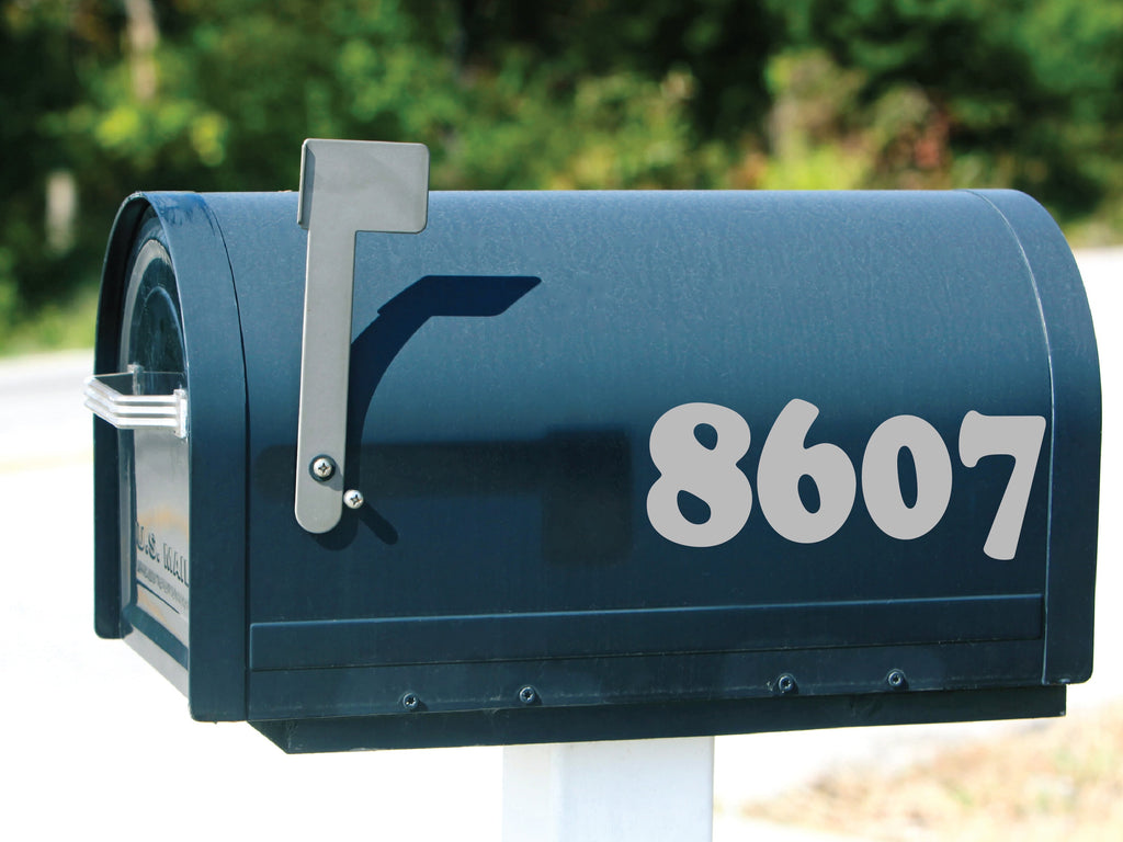 Black mailbox adorned with Custom Bold Numbers Decal in light gray, showcasing contrast and visibility.