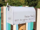White mailbox with custom family name vinyl decal and house number