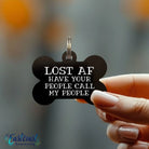 Funny black bone-shaped dog ID tag engraved with “Lost AF Call My People” hanging from a dog collar