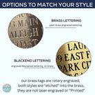 Custom engraved brass luggage tag with leather strap, perfect for travel or gifts.