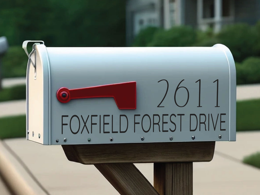 Personalized mailbox number decal applied to curb-side mailbox