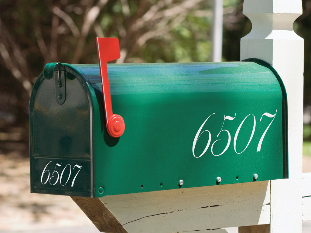 Green mailbox accented with a light brown mailbox number decal, providing a natural and subtle contrast.