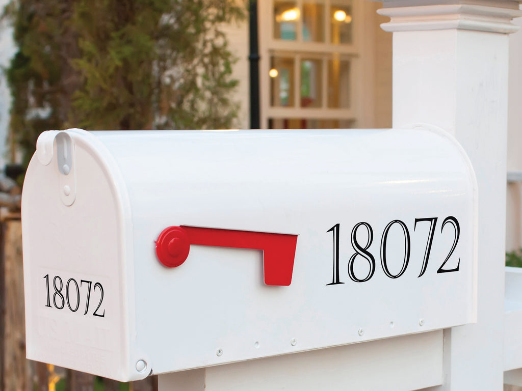 White residential mailbox featuring bold black mailbox numbers decal, showcasing sharp contrast for easy reading.