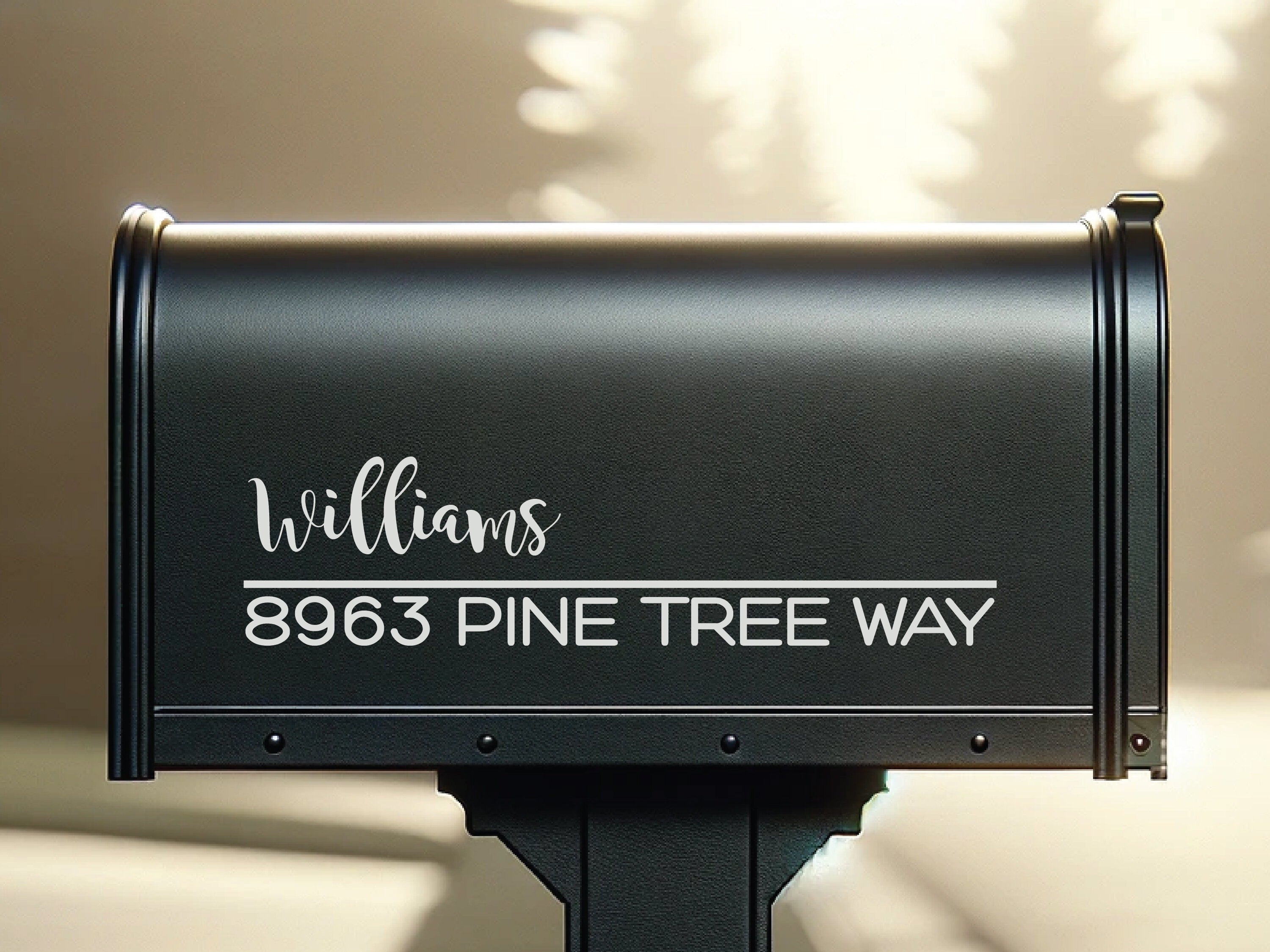 Close-up of white mailbox address decal applied to black mailbox