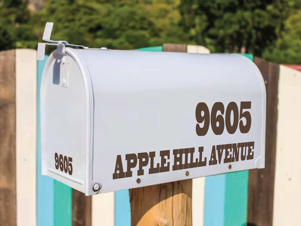 White mailbox with custom decal numbers '9605' and street name 'APPLE HILL AVENUE' in large, black, handwritten-style font.