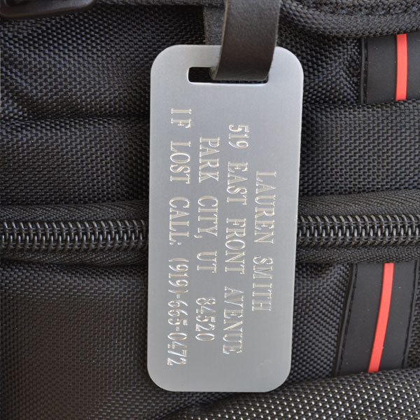  	 If you travel frequently and are in need of durable luggage tags, our silver luggage tag is made from a high quality aluminum and is engraved with a clear bold font so your information can be read easily. You can customize this tag with up to four lines of text. This silver id tag comes with a leather strap which has a matching silver buckle. Having Personalized luggage tags ensures that if your luggage is lost someone will know how to contact you.